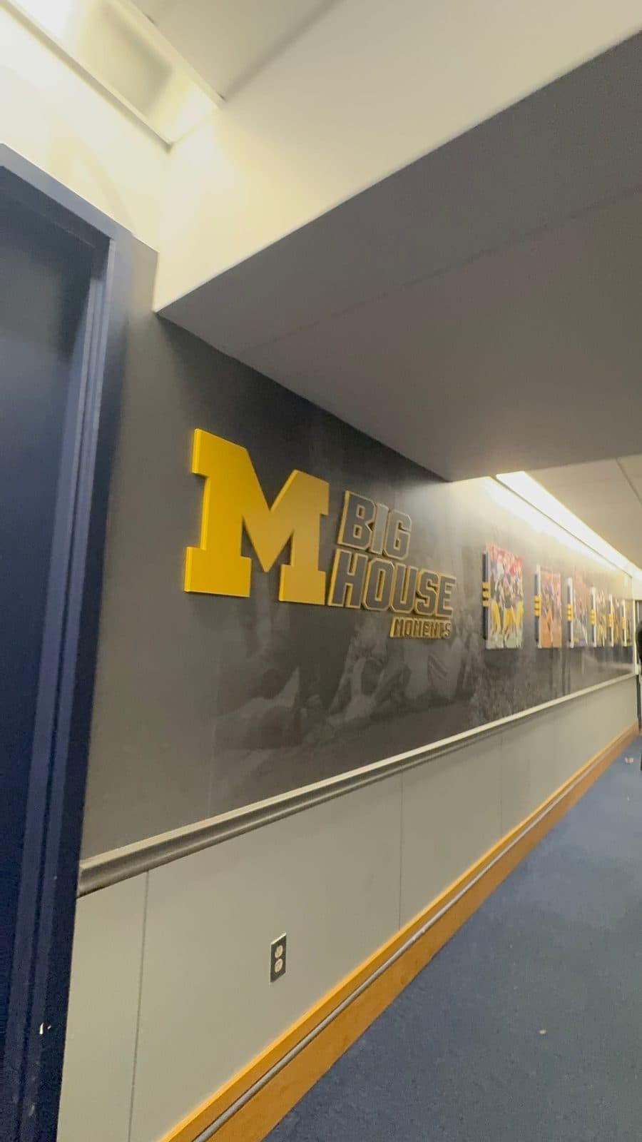 Hallway wall with a block M and Big House Moments sign