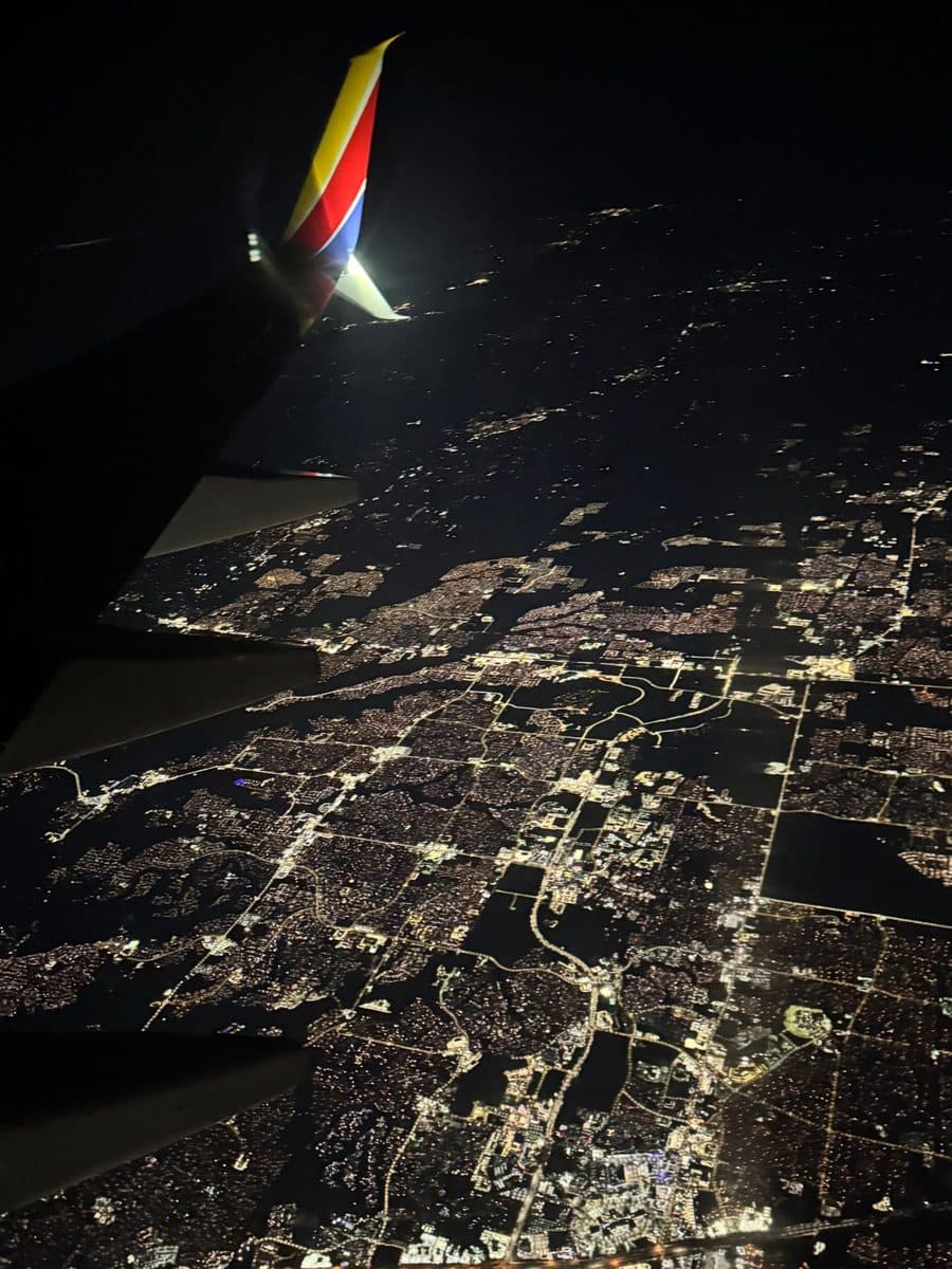Southwest plane wing over city lights at night