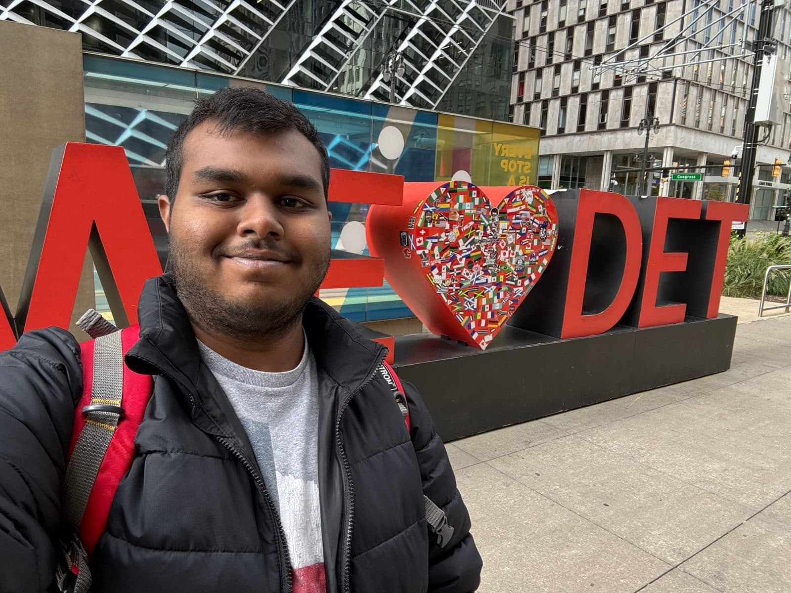 Vishanth selfie in front of a large We Heart DET sign