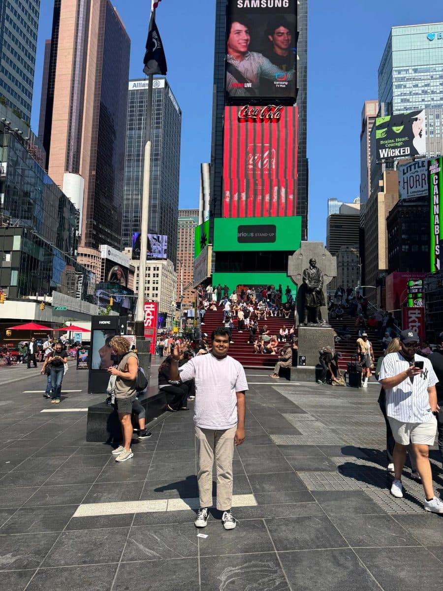 Vishanth waving in Times Square on a sunny day